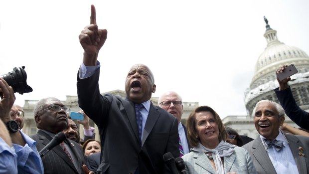 Democrat John Lewis, centre, speaks on Capitol Hill in Washington after House Democrats ended their sit-in. 