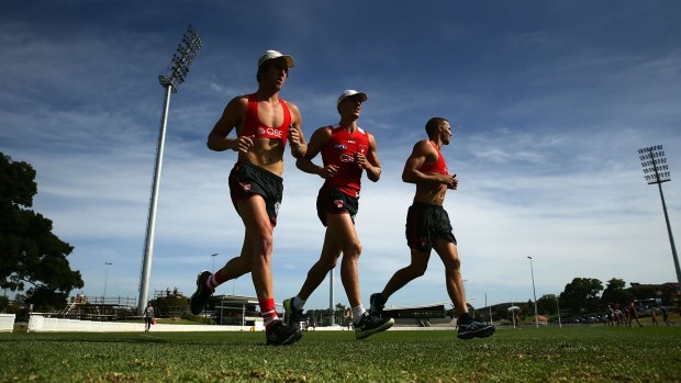 Ted Richards and Sam Reid warm up during a Sydney Swans training session at Drummoyne Oval on Wednesday.