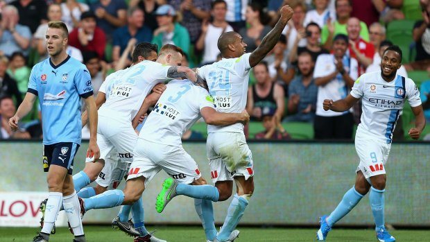 On target: Melbourne City's Aaron Hughes celebrates after scoring a goal against Sydney FC on Saturday night.
