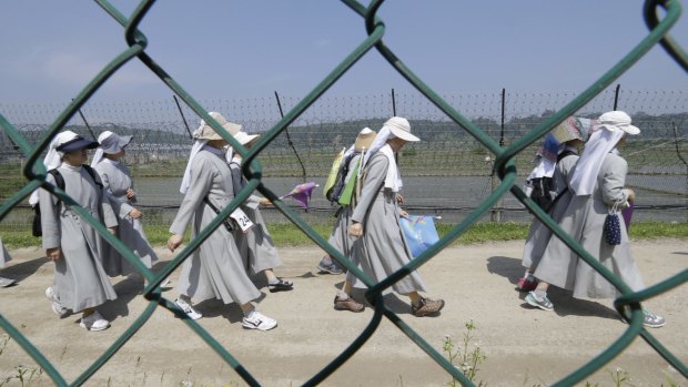 South Korean Catholic nuns march along the military wire fences at the North Korean border during a 'walk for peace'.