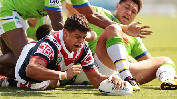 In the thick of it: Latrell Mitchell scoring against the Raiders.