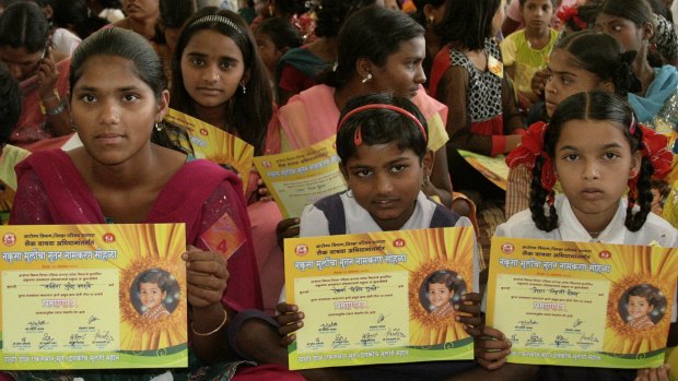 Indian girls hold certificates giving them new names and a new start. Given names such as "Nakusa" or "Nakushi", meaning "unwanted" in Hindi, they grew up understanding they were a burden in families that preferred boys.