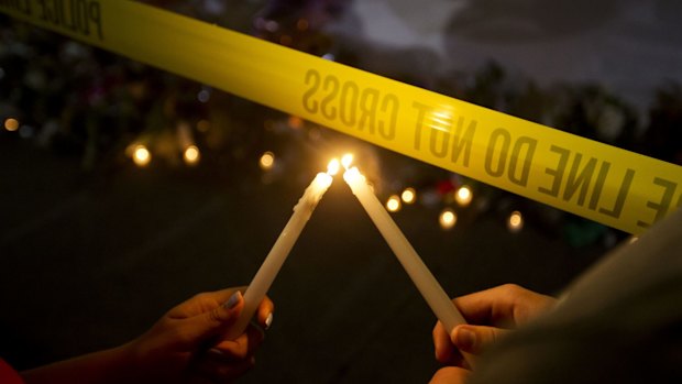 Candles at a sidewalk memorial in front of Emanuel AME Church where nine people were killed by a white gunman.