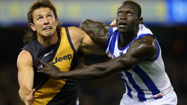 Ivan Maric of the Tigers and Majak Daw of the Kangaroos compete in the ruck.