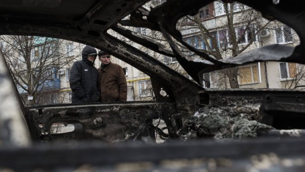 A burnt-out car – the result of a rocket attack – in the Vostochniy district of Mariupol in eastern Ukraine on Sunday. 