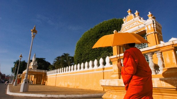A monk walks outside Phnom Penh's Royal Palace.