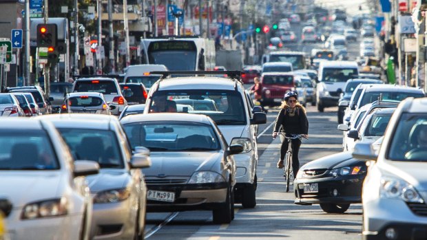 Trading parking and speed for safety, a cyclist rides on Sydney Road, Coburg.