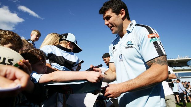 Retiring Shark Michael Ennis mingles with fans on Tuesday. 