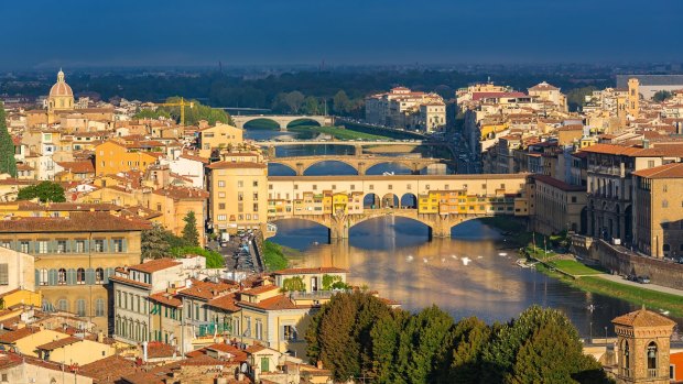 Florence, with its medieval Ponte Vecchio stone arched bridge over the Arno River.