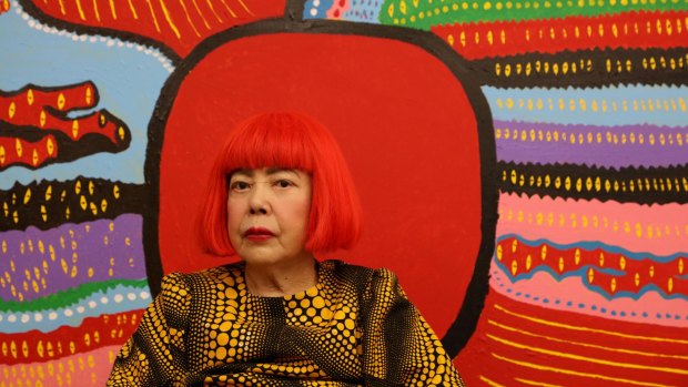 Yayoi Kusama in front of Life is the Heart of a Rainbow.