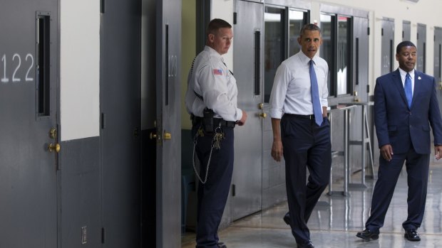 Cell 123: Obama is led on a tour by Bureau of Prisons Director Charles Samuels, right, and correctional officer Ronald Warlick.