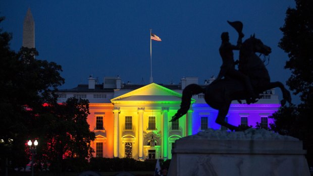 The White House stands illuminated in rainbow coloured light at dusk in Washington, D.C.