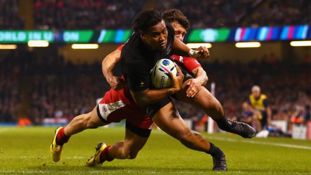 All Blacks' Julian Savea scores his team's sixth try and completes his hat trick as Giorgi Aptsiauri of Georgia tries to stop him at the Millennium Stadium in Cardiff, United Kingdom.  