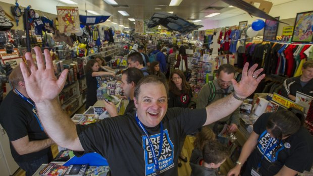 Impact Comics owner Mal Briggs treating comic book fans at his store as part of the international Free Comic Book Day.