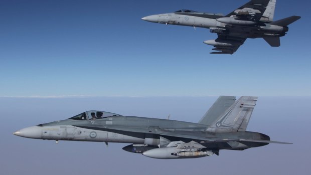 F/A-18A Hornets from Australia's Air Task Group fly in formation with a Royal Australian Air Force KC-30A Multi Role Tanker Transport aircraft.