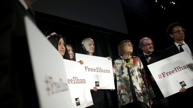 A group holds up signs in support of the jailed Chinese writer Ilham Tohti, including Salman Rushdie (second from right) at the PEN American Centre Literary Gala in New York in 2014.