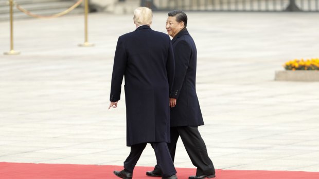 Donald Trump strolls with Xi Jinping during a welcome ceremony outside the Great Hall of the People in Beijing, China, on Thursday