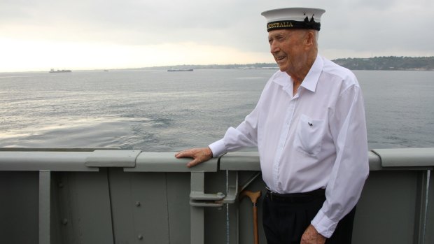 Bill Quinn, with his HMAS Australia cap on, on the deck of HMAS Canberra overlooking Iron Bottom Sound.