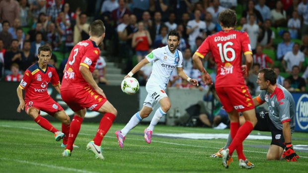 No way out: A surrounded David Villa has his shot blocked by Adelaide goalkeeper Eugene Galekovic.