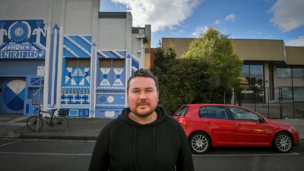 Brendan Brogan outside Howler, with the site of the proposed apartment block next door. 