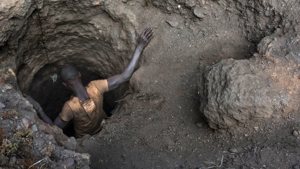 A "creuseur" descends into a tunnel at the mine in Kawama. About 100,000 cobalt miners in Congo use hand tools to dig hundreds of feet underground with little oversight and few safety measures, according to workers, government officials and evidence found.