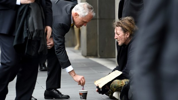 Prime Minister Malcolm Turnbull gives a homeless man five dollars. An elite group with incomes above $1 million give more than one fifth of all donations.