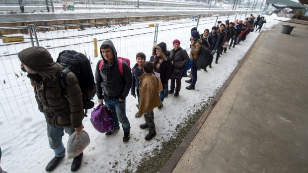 Refugees walk to a chartered train at the railway station of Passau, Germany on Tuesday. Migrants and refugees continue to arrive in Germany to seek for asylum. 