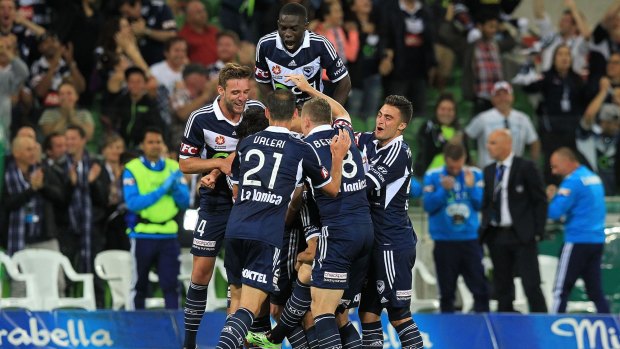 Melbourne Victory players celebrate the goal by Gui Finkler against Newcastle Jets on Saturday.