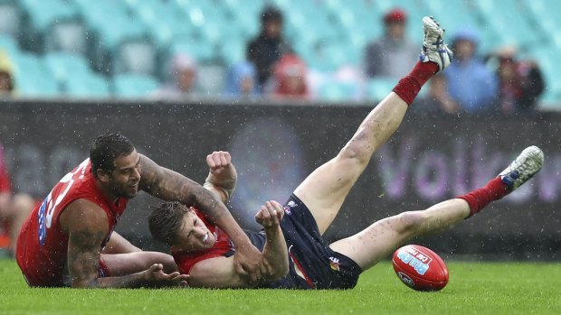 Wet and wild: Lance Franklin tackles Sam Frost.
