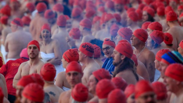 Participants prepare before the Nude Solstice Swim, as part of the Dark Mofo winter festival. The researchers wanted to find out if people do things they might not do otherwise when they are in a group.