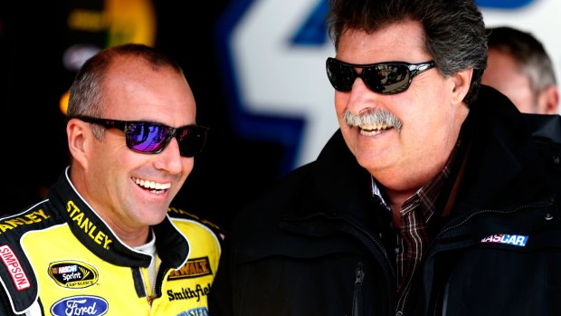 Marcos Ambrose talks to NASCAR president Mike Helton during practice for the NASCAR Sprint Cup Series at Chicagoland Speedway on Saturday.