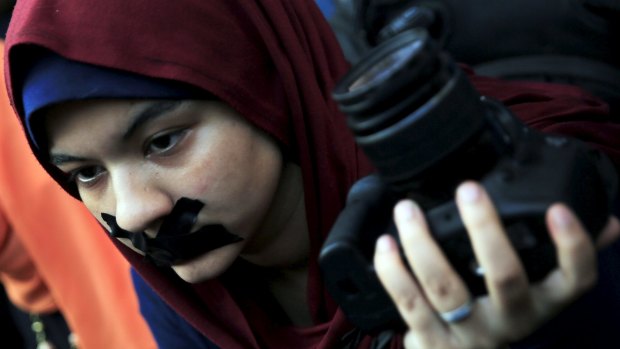 A news photographer with her mouth taped during a protest against the detention of Ahmed Ramadan, a photojournalist with Egyptian private newspaper <i>Tahrir</i>, in Cairo, on Monday.