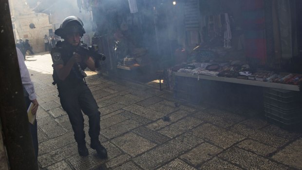 An Israeli border police officer is seen during clashes with Palestinian protesters in Jerusalem's Old City on Tuesday, the third straight day of unrest at Jerusalem's most sensitive holy site.