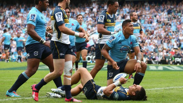 Unstoppable: Israel Folau goes over for the Waratahs.