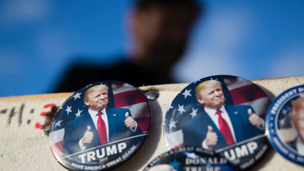 Vendors sell Donald Trump buttons as preparations continue for Friday's inauguration.