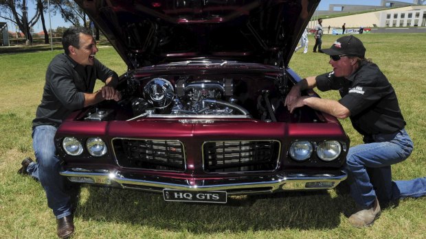 Site Manager for the car festival, Dave "Colorado" Chappell, right and Andy Lopez, Summernats co-owner, left, check out this immaculate HQ Holden Monaro GTS coupe. 
