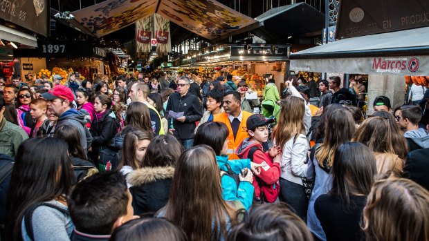 A security staff member controls access to 'La Boqueria' in Barcelona, Spain.Barcelona has been struggling with large numbers of tourists for years. 