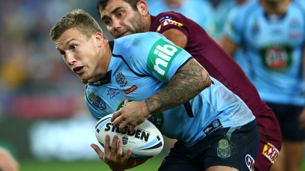Under fire: Trent Hodkinson is tackled by Cameron Smith during game one of the State of Origin series.