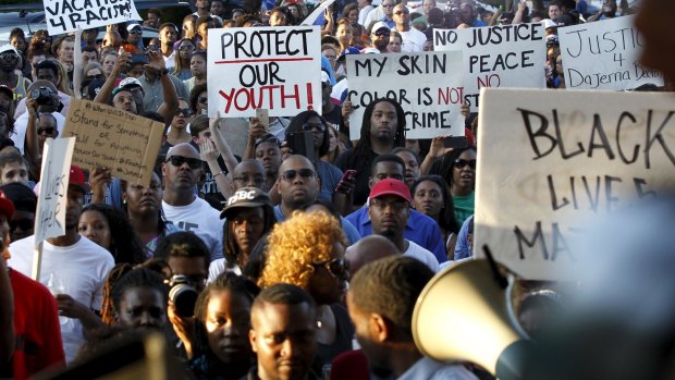 Hundreds of protesters marched through the Dallas-area city of McKinney on Monday calling for the firing of police officer Eric Casebolt, seen in a video throwing a bikini-clad teenage girl to the ground and pointing his pistol at youths.