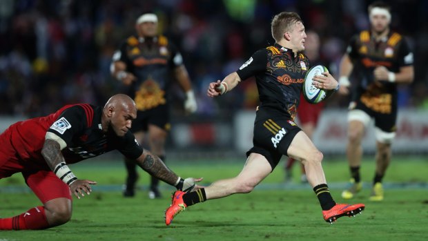 Clean set of heels: Damian McKenzie escapes the clutches of Nemani Nadolo.