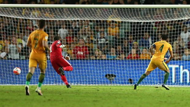 Back of the net: Tim Cahill slots the ball home for Australia.