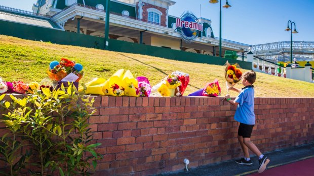 Bouquets are now being left at Dreamworld in memory of the four victims.