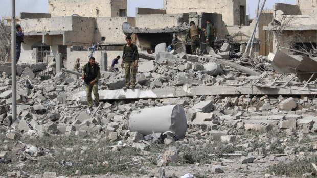 Kurdish Peshmerga forces inspect a destroyed building belonging to Islamic State militants on the outskirts of Tel Ward, west of Kirkuk, in northern Iraq.