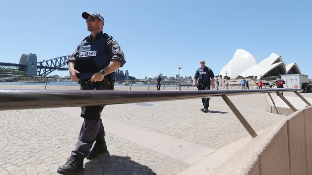 Armed police patrol near the Sydney Opera House on December 15.