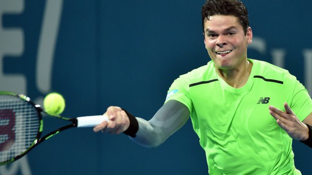 Milos Raonic stretches to play a forehand.