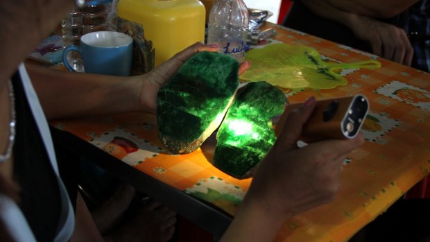 Local people examine the quality of a jade stone in the Hpakant area of Kachin state, northern Myanmar last month. 