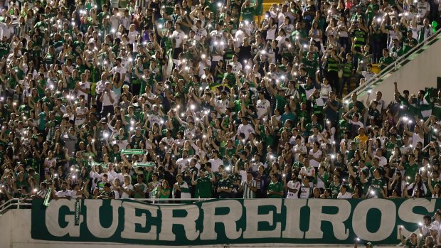 Supporters of Brazil's Chapecoense gather for a memorial for the players who died in a plane crash in Colombia, at Arena Condado stadium in Chapeco, Brazil, on November 30. The banner reads "warriors".