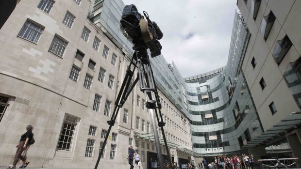 A television news camera points at the main entrance to the BBC headquarters and studios in Portland Place, London on Thursday. 