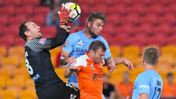 City goalkeeper Eugene Galekovic in action as Bart Schenkeveld and Roar's Avram Papadopoulos compete.