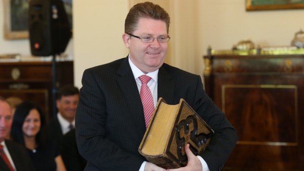 Senator Scott Ryan, carrying a family bible, was sworn in as Minister for Vocational Education and Skills.